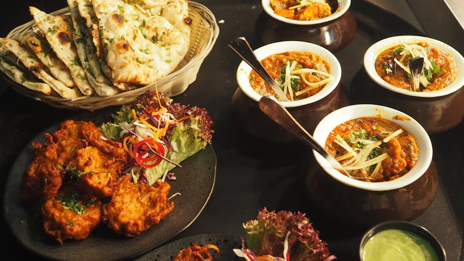 pexels-photo-958545-958545 A mouth-watering display of Indian cuisine featuring naan, curry, and pakoras perfect for a delightful meal.