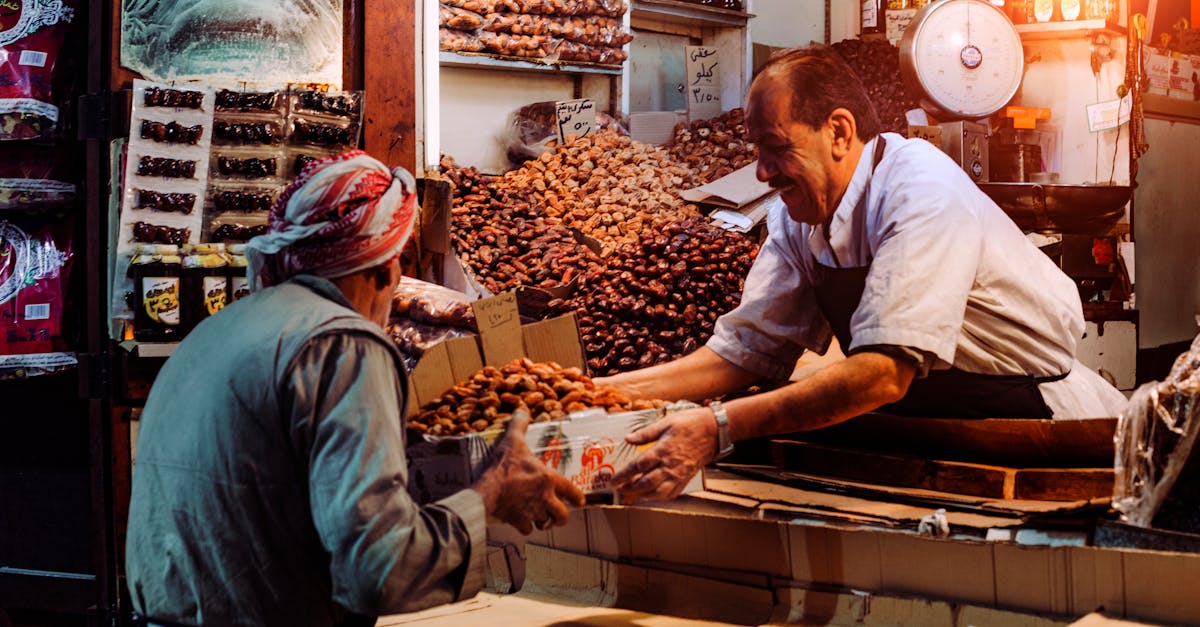 Two men exchanging dates in a vibrant Dubai spice market stall.